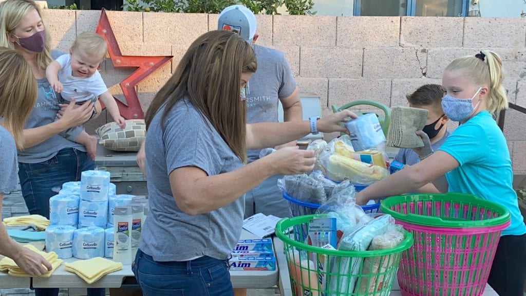 families pack laundry baskets with personal care items 